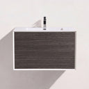 A modern wall-mounted bathroom vanity with two dark brown graphite wood drawers, a white top, and a black faucet, shown against a plain off-white wall.