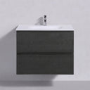 A modern 26-inch wall-mounted bathroom vanity with a dark charcoal black oak wood-grain finish, a white integrated sink countertop, and a chrome faucet, shown against a light gray wall.