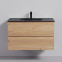 A modern 34-inch floating bathroom vanity with a light oak wood cabinet, a matte black countertop, and an integrated black sink with a tall matte black faucet, shown against a neutral gray wall.