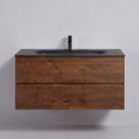 A modern floating 42-inch bathroom vanity with a matte black integrated sink and rich brown rose wood-grain cabinet, shown with two lower drawers pulled open against a light gray wall.