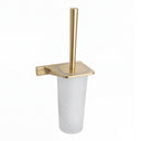 A modern toilet brush holder with a brushed gold metal base, a matching vertical brush handle, and a frosted white cylindrical cup, shown on a plain white background.