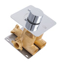 A modern wall-mounted single-handle shower valve trim with a polished chrome square faceplate and cylindrical knob, paired with a polished brass valve body and a dark metal mounting plate, shown on a white background.