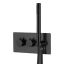 A modern wall-mounted shower system with two round matte black control knobs on a rectangular backplate, a vertical matte black hand shower rod, and a coiled flexible hose, shown against a plain white background.