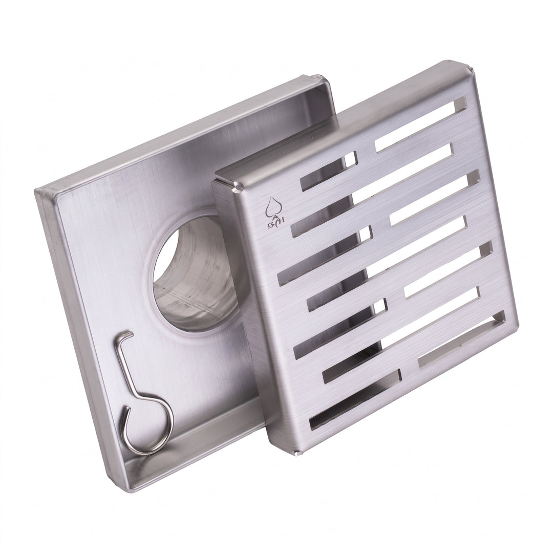 A stainless steel floor shower drain assembly with a square slotted grate cover and a matching square drain body featuring a circular opening and a hanging hook, shown on a plain white background.