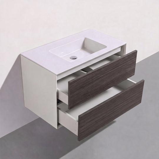 A modern wall-mounted bathroom vanity with a white integrated sink and two dark brown graphite wood drawers, shown floating against a neutral gray and white background.