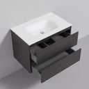 A modern 34-inch wall-mounted bathroom vanity with a matte white integrated sink top and dark black oak wood-grain cabinet, shown with two lower drawers partially open against a light gray wall.