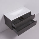 A modern 42-inch wall-mounted bathroom vanity with a matte white integrated sink countertop and dark charcoal black oak wood-grain cabinet, shown with two lower drawers pulled open against a light gray wall.