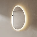 BAI 21010 modern 23-inch droplet shaped LED bathroom mirror with anti fog and frosted edge design with warm lighting side view.