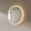 BAI 21011 modern minimalist round 30-inch bathroom vanity mirror with a glowing warm LED light ring, mounted on a textured beige plaster wall side view.