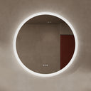 BAI 21012 modern minimalist round 36-inch bathroom vanity mirror with a glowing white LED light ring, mounted on a textured beige plaster wall.