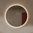 BAI 21012 modern minimalist round 36-inch bathroom vanity mirror with a glowing warm LED light ring, mounted on a textured beige plaster wall.