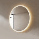 BAI 21012 modern minimalist round 36-inch bathroom vanity mirror with a glowing warm LED light ring, mounted on a textured beige plaster wall side view.