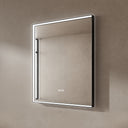 BAI 21021 modern rectangular 30-inch wall-mounted mirror with a slim white LED light and a black frame, shown against a textured beige wall. The mirror has small control touch sensor dots near the bottom center.