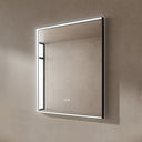 BAI 21022 modern rectangular 34-inch wall-mounted mirror with a slim white LED light and a black frame, shown against a textured beige wall. The mirror has small control touch sensor dots near the bottom center.