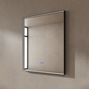 BAI 21022 modern rectangular 34-inch wall-mounted mirror with a slim LED light switched off and a black frame, shown against a textured beige wall. The mirror has small control touch sensor dots near the bottom center.