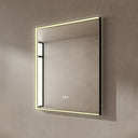 BAI 21022 modern rectangular 34-inch wall-mounted mirror with a slim warm LED light and a black frame, shown against a textured beige wall. The mirror has small control touch sensor dots near the bottom center.