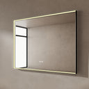 BAI 21024 modern rectangular 47-inch wall-mounted mirror with a slim warm LED light and a black frame, shown against a textured beige wall. The mirror has small control touch sensor dots near the bottom center.