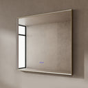 BAI 21033 modern rectangular 40-inch wall-mounted mirror with a slim LED light that's off with gold frame, shown against a textured beige wall. The mirror has small control touch sensor dots near the bottom center.