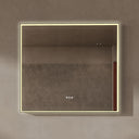 BAI 21033 modern rectangular 40-inch wall-mounted mirror with a slim warm LED light with gold frame, shown against a textured beige wall. The mirror has small control touch sensor dots near the bottom center.