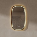 BAI 21041 modern oval wall-mounted vanity bathroom led mirror with a slim gold frame and integrated LED lighting, shown against a textured beige wall with warm front and side lighting.