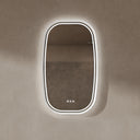 BAI 21042 modern oval LED-backlit wall bathroom mirror with a white frame and illuminated border, mounted on a textured beige plaster wall.