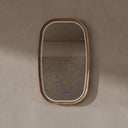 BAI 21043 modern oval wall-mounted led bathroom mirror with a light wood oak frame and integrated LED lighting, shown on a textured beige wall with the lights off.