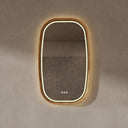 BAI 21043 modern oval wall-mounted led bathroom mirror with a light wood oak frame and integrated LED lighting, shown on a textured beige wall with warm lighting.