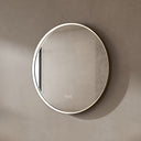 BAI 21051 modern minimalist round 32-inch bathroom vanity mirror with a glowing white LED light ring and a gold frame, mounted on a textured beige plaster wall.