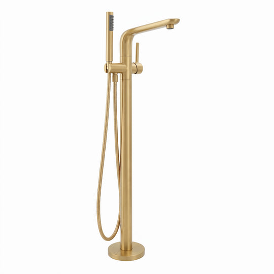 A modern freestanding bathtub faucet in brushed brass/gold finish, featuring a tall central column, angled spout, round base, and a matching handheld shower head with a flexible hose, shown on a plain white background.