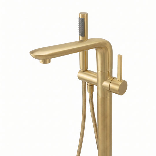 A modern freestanding bathtub faucet in brushed gold with an integrated handheld shower head and flexible hose, shown against a plain white background.