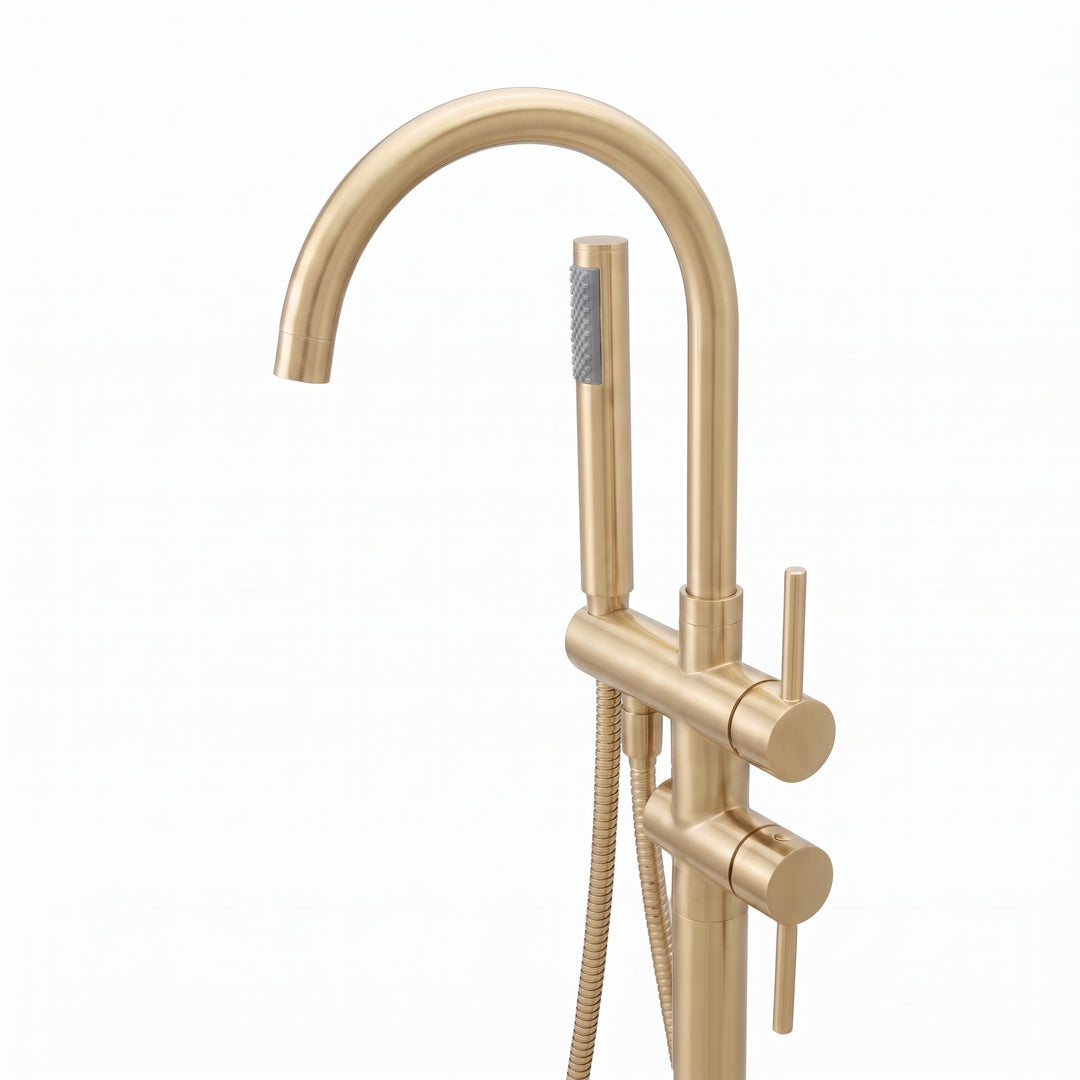 A modern freestanding bathtub faucet set in a brushed gold finish, featuring a tall curved gooseneck spout, a vertical support column with a round base, a slide valve, and a handheld shower head with a flexible hose, shown on a plain white background.