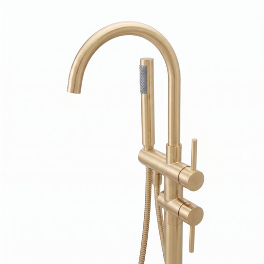 A modern freestanding bathtub faucet set in a brushed gold finish, featuring a tall curved gooseneck spout, a vertical support column with a round base, a slide valve, and a handheld shower head with a flexible hose, shown on a plain white background.