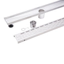 A stainless steel outdoor shower drain channel kit with a long channel trough, a perforated drain grate, a mounting bracket, a small metal cup, and a small hook, displayed on a clean white background.