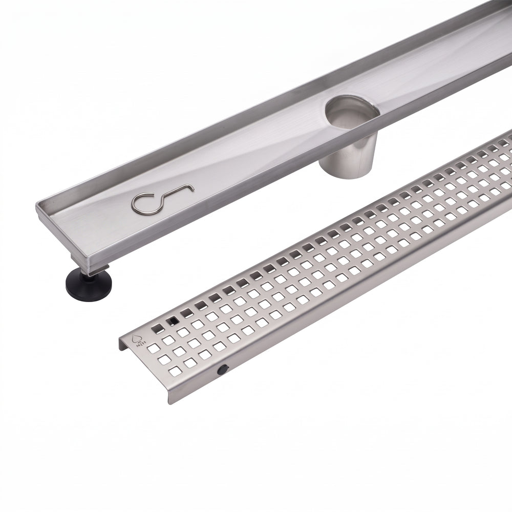 A stainless steel linear channel drain with a slotted grate section and a circular opening, shown on a clean white background.